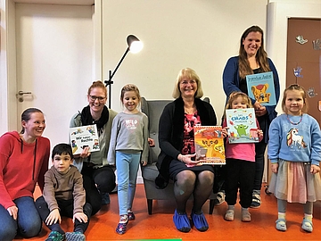Kinder, Kita-Fachkräfte und Bürgermeisterin von Pinneberg am Vorlesetag mit Büchern
